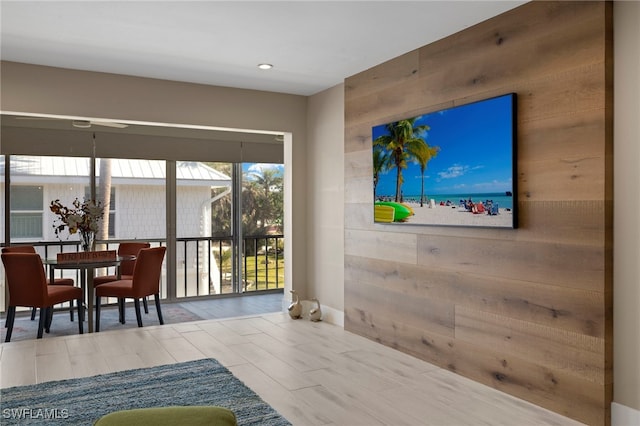 doorway to outside featuring hardwood / wood-style flooring and wood walls