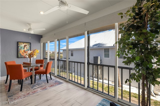 sunroom / solarium featuring ceiling fan