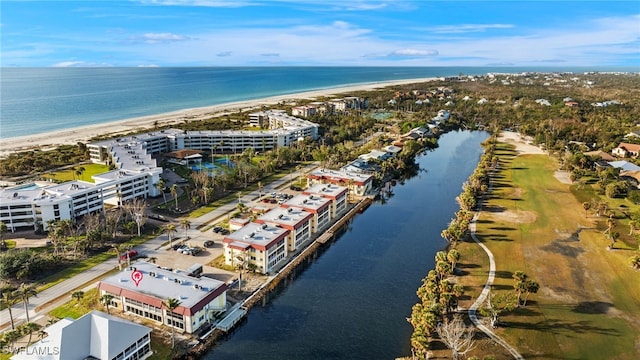 drone / aerial view featuring a water view and a beach view