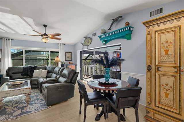 dining room with lofted ceiling, light wood-type flooring, and ceiling fan