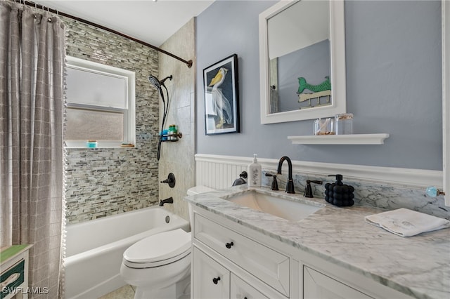 full bathroom with vanity, shower / tub combo, and toilet