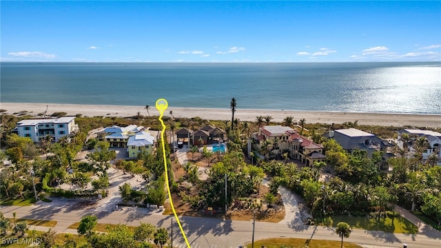 aerial view with a water view and a beach view