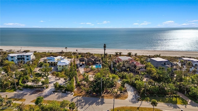 drone / aerial view featuring a beach view and a water view