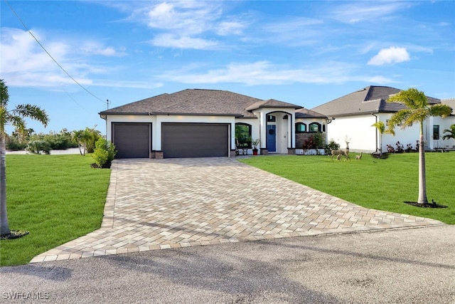 single story home featuring a garage and a front lawn