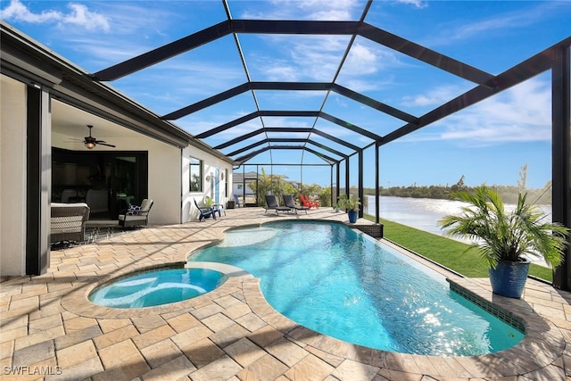 view of pool with a lanai, a water view, a patio, and an in ground hot tub