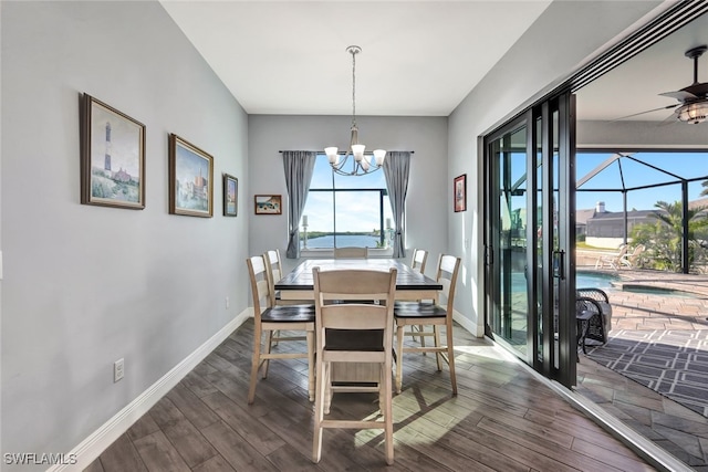 dining space featuring ceiling fan with notable chandelier