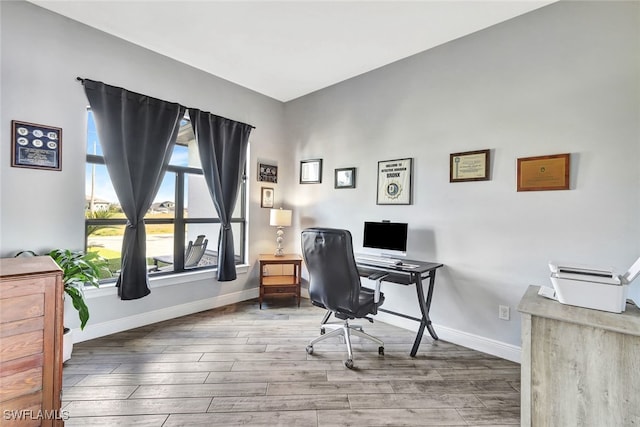 home office with hardwood / wood-style floors