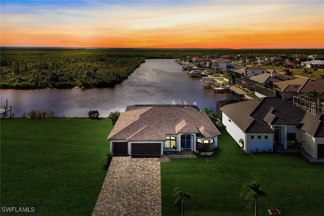 aerial view at dusk with a water view