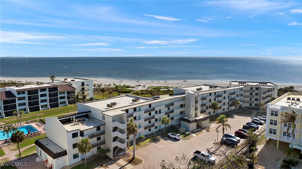 birds eye view of property with a view of the beach and a water view