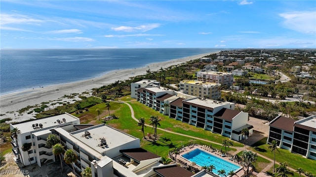 birds eye view of property with a water view and a beach view