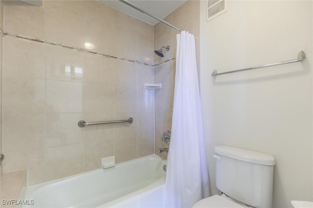 bathroom featuring shower / bath combination with curtain and toilet