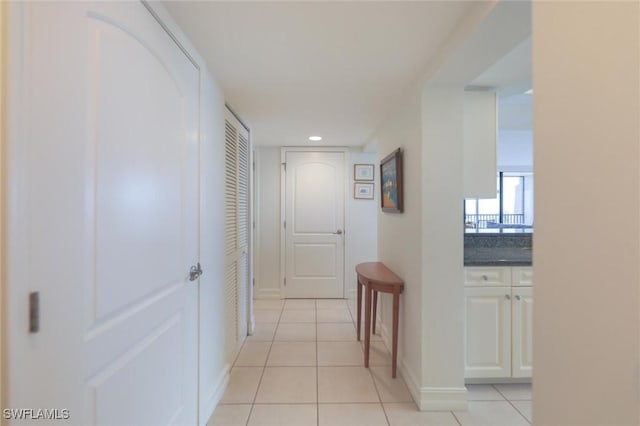 corridor with light tile patterned flooring