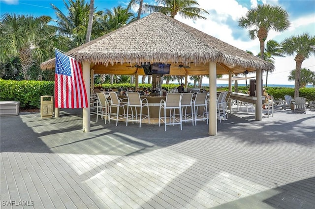 view of property's community with a gazebo and a bar