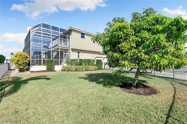 back of property with a lawn and a lanai