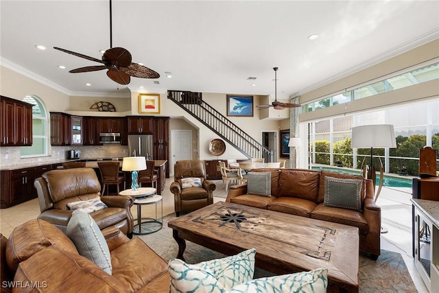 tiled living room featuring ceiling fan and ornamental molding