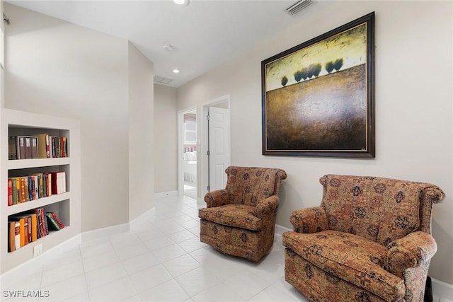 living area with light tile patterned flooring and built in features