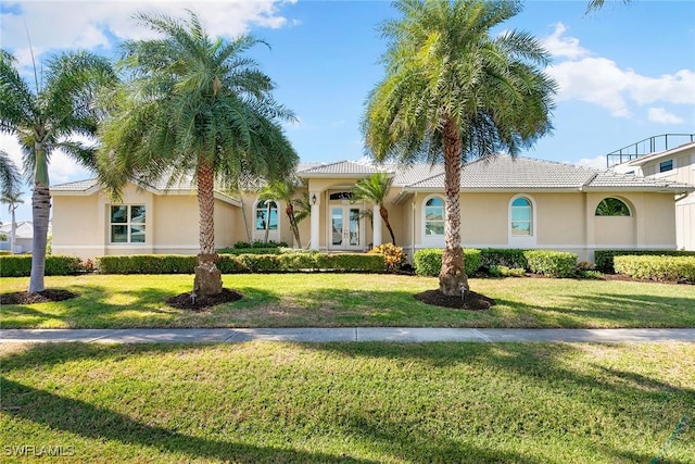 mediterranean / spanish-style home with a front lawn