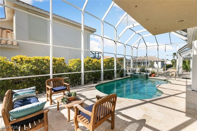 view of pool with a patio and glass enclosure