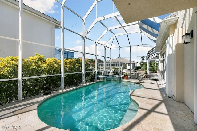 view of pool with a lanai and a patio