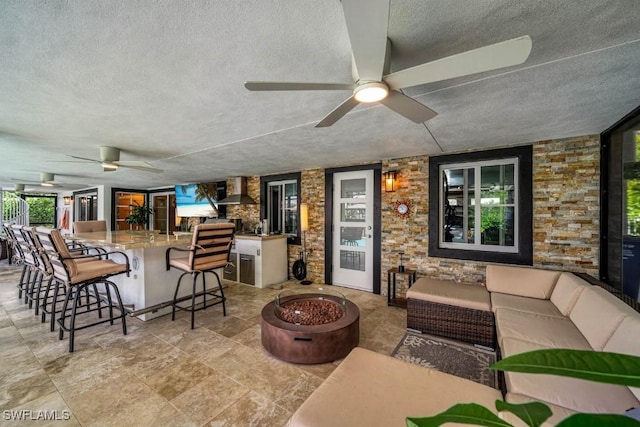 interior space featuring ceiling fan and a textured ceiling