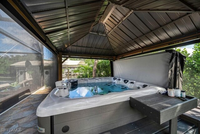 view of patio featuring a gazebo and a hot tub