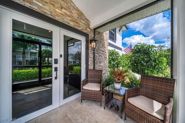 doorway featuring vaulted ceiling with beams