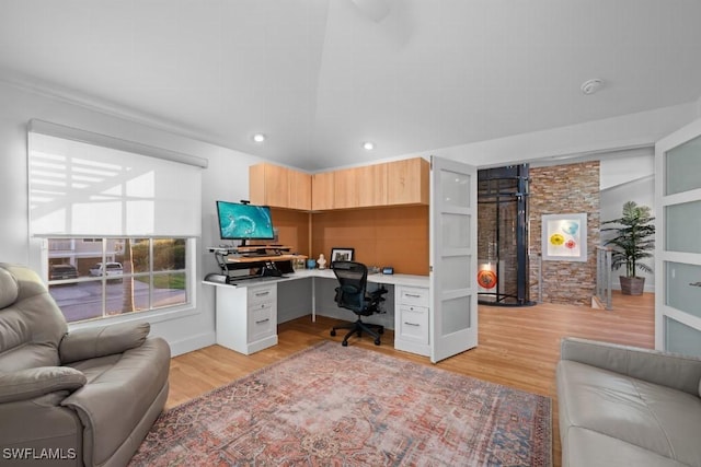 office with light hardwood / wood-style floors and built in desk