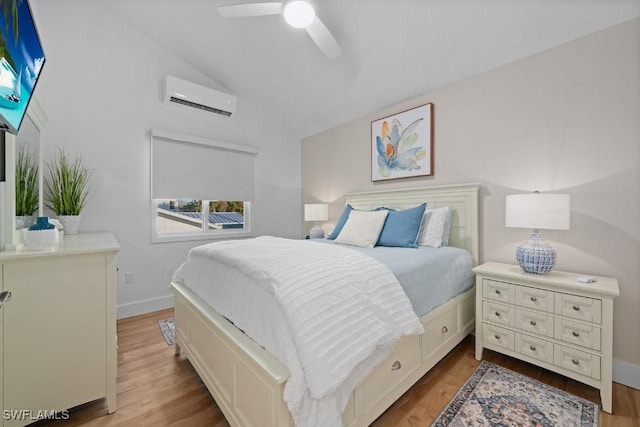 bedroom featuring ceiling fan, light hardwood / wood-style floors, lofted ceiling, and a wall unit AC