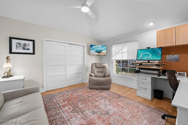 office featuring ceiling fan, light hardwood / wood-style floors, and vaulted ceiling