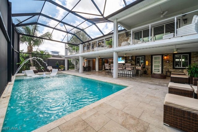 view of pool featuring a patio area, ceiling fan, outdoor lounge area, and an outdoor bar