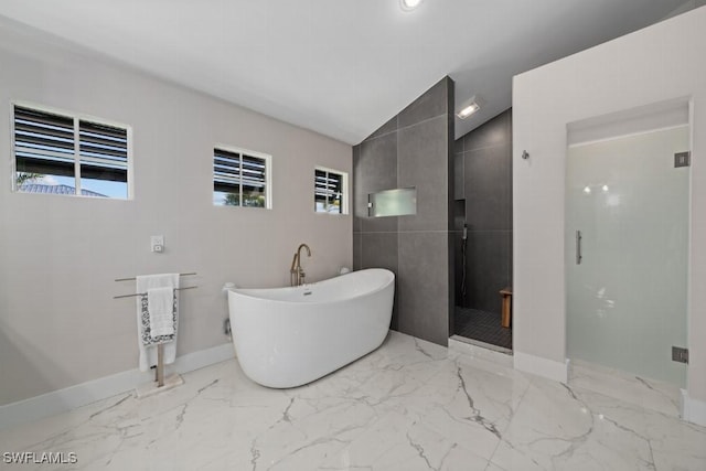 bathroom featuring tile walls, vaulted ceiling, and shower with separate bathtub