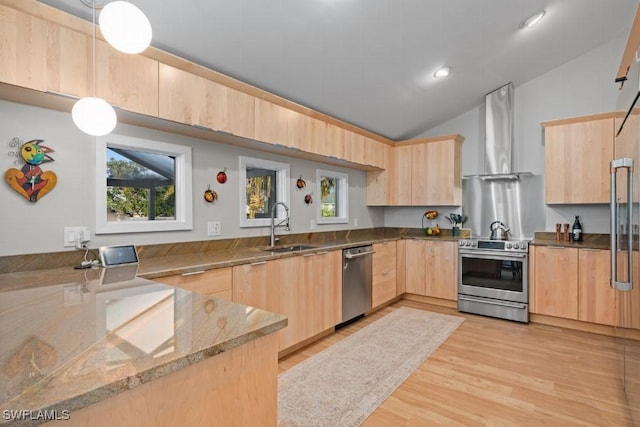 kitchen with light brown cabinets, hanging light fixtures, vaulted ceiling, kitchen peninsula, and stainless steel appliances