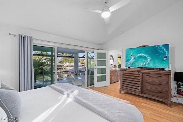 bedroom featuring hardwood / wood-style flooring, ceiling fan, access to exterior, and vaulted ceiling