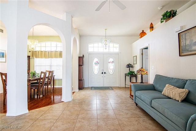 entrance foyer featuring light hardwood / wood-style flooring and ceiling fan with notable chandelier