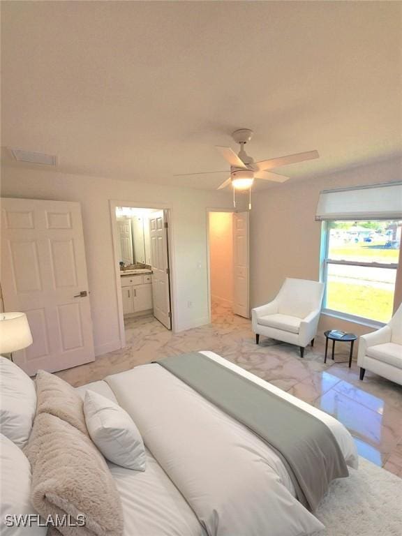 bedroom featuring marble finish floor, connected bathroom, and ceiling fan