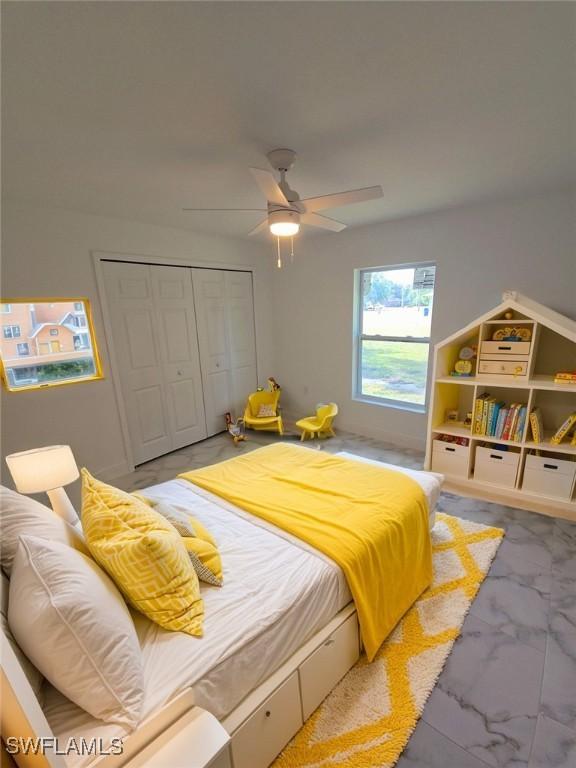 bedroom with ceiling fan and a closet