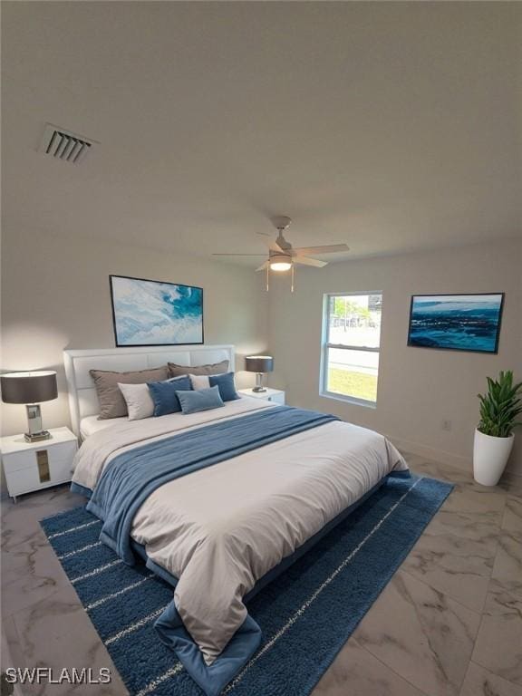 bedroom featuring marble finish floor, visible vents, and ceiling fan