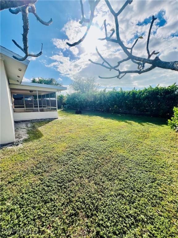 view of yard with a sunroom