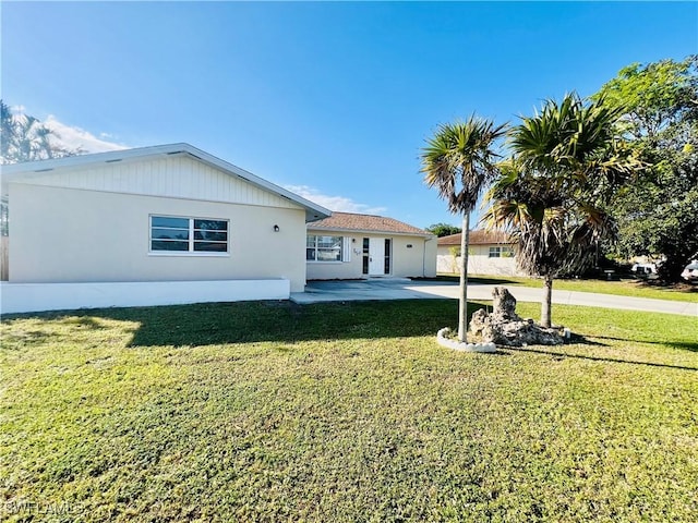 view of front of property with a front lawn and a patio area