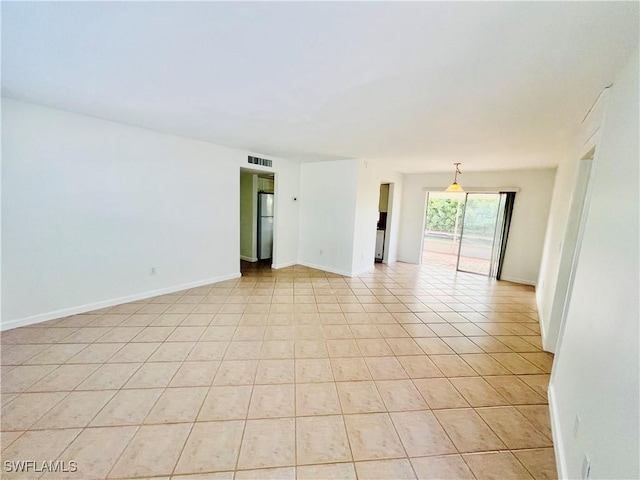 spare room featuring light tile patterned floors