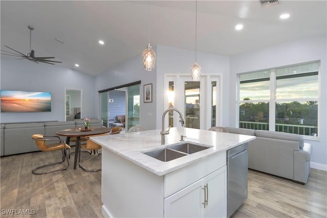 kitchen featuring plenty of natural light, dishwasher, white cabinetry, and sink