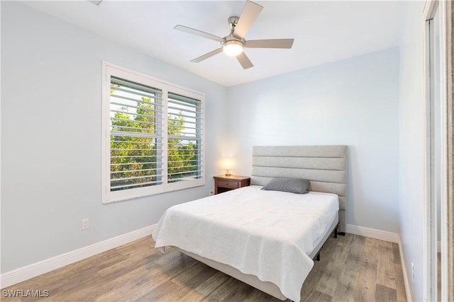 bedroom with light hardwood / wood-style floors and ceiling fan