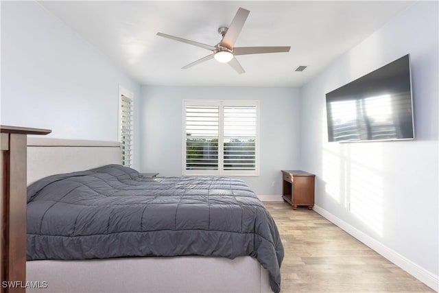 bedroom with ceiling fan and light hardwood / wood-style flooring