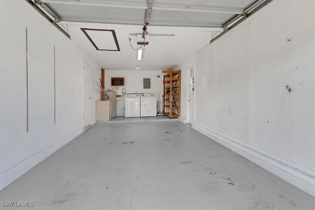 garage featuring independent washer and dryer and a garage door opener