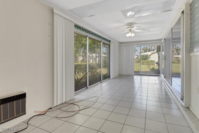 unfurnished sunroom with ceiling fan