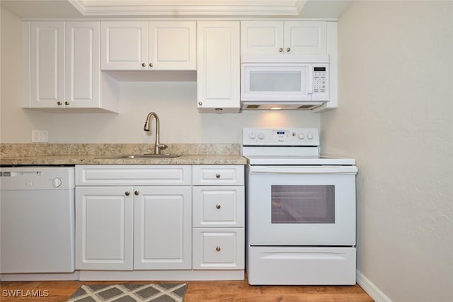 kitchen featuring sink, white appliances, and white cabinets