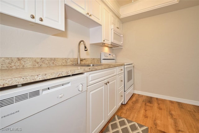 kitchen featuring white cabinetry, sink, white appliances, and light wood-type flooring