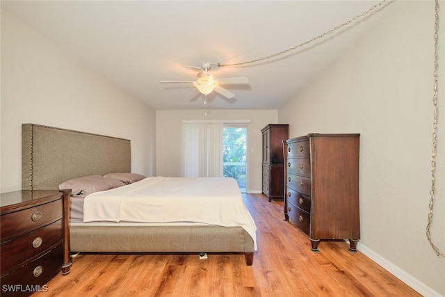 bedroom featuring access to outside, ceiling fan, and light wood-type flooring