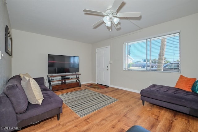 living room featuring hardwood / wood-style floors and ceiling fan