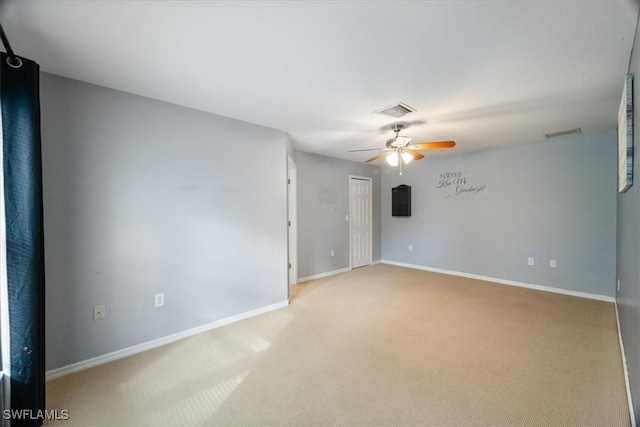 spare room with light carpet and ceiling fan